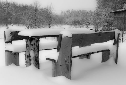 Winter magic scenery, table chairs on white black