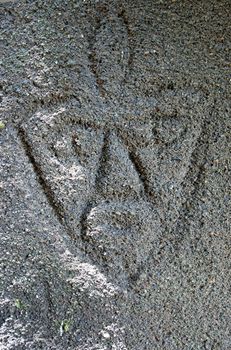 Drawing of  a face in the sand 