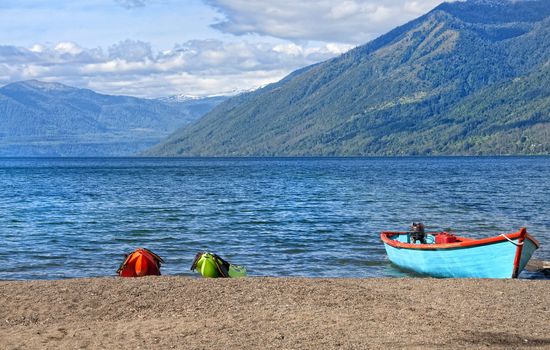 Boats resting on the shore of a lake on the outskirts of Pucon, Chile 