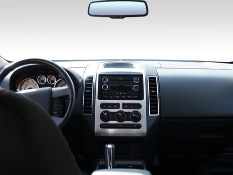 View of the interior of a modern automobile showing the dashboard and rear view mirror. A clipping path of the windshield and mirror are included so you can replace it with whatever you like!