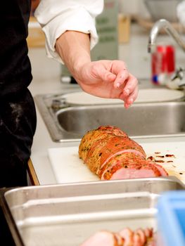 Chef preparing ham in  kitchen
