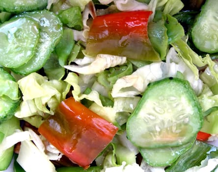 Green salad with lettuce and vegetables, peppers, cucumbers