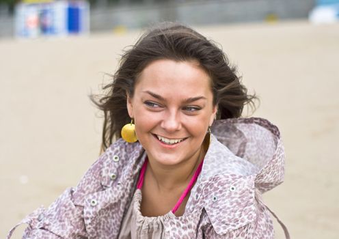 Cute attractive women smiling at the beach. Summer portrait. Blurring background.