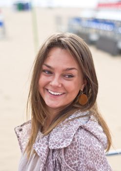 Cute attractive women smiling at the beach. Summer portrait. Blurring background.