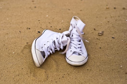 White shoes on the sand. Summer, beach, outdoor.