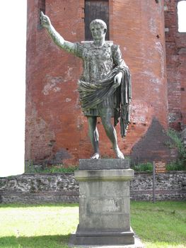 Roman statue of Caesar Augustus in front of roman walls