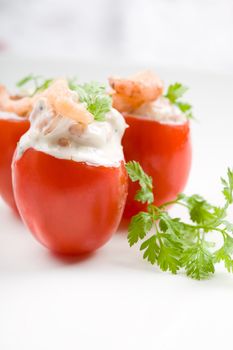 Small cherry tomatoes filled with shrimp cocktail