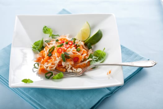 Delicious asian salad with carrot, cabbage, limejuice and peppers