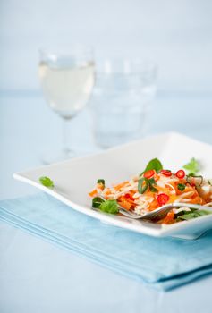 Delicious Asian carrot salad served with a glass of white wine