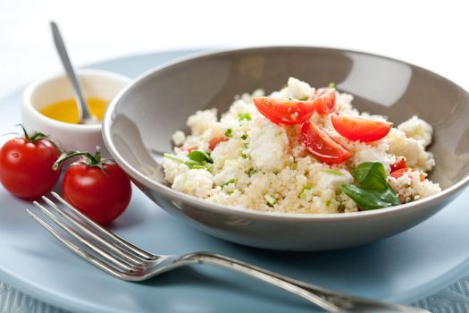 Delicious fresh couscous salad with tomatoes and basil
