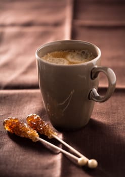 Delicious morning coffee with two brown sugar canes