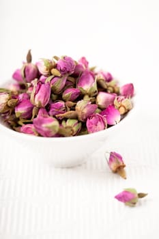 Small pink rosebuds dried in a bowl