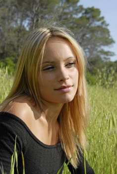 young blond teenagertanning in a garden