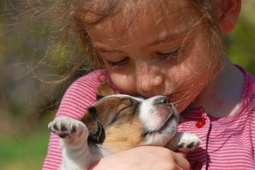 little girl and her very young puppy jack russel terrier