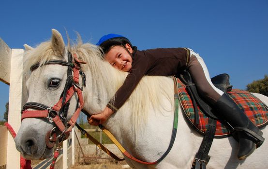 little girl and her best friend white shetland pony