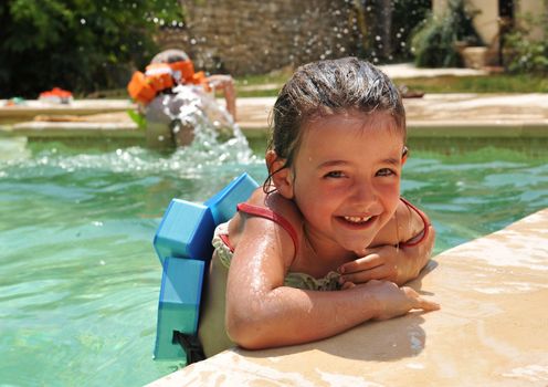 smiling little girl in a swimming pool