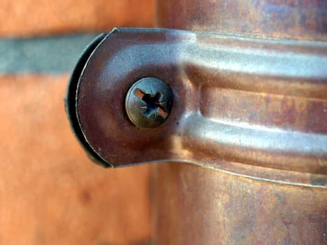 Detail of copper rain pipe with screw