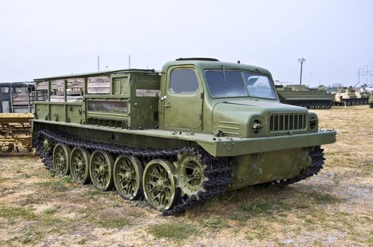 Old Army heavy all-terrain vehicle on tracks. Used to move goods and foot.