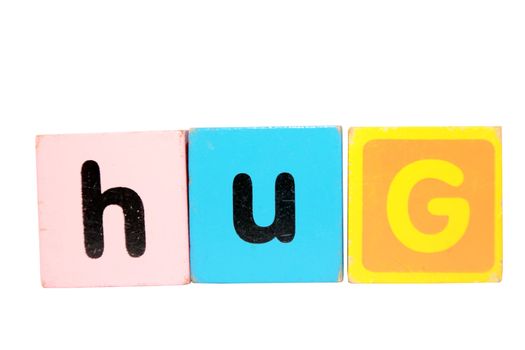 assorted childrens toy letter building blocks against a white background that spell hug with clipping path