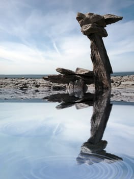 standing stones on the burren in ireland reflected in water