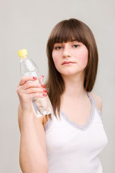 Portrait of young girl with bottle of water