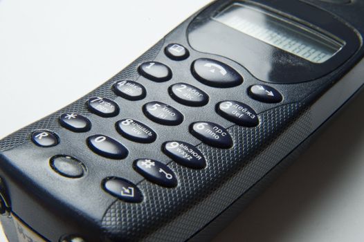 The black handset telephone on the white background
