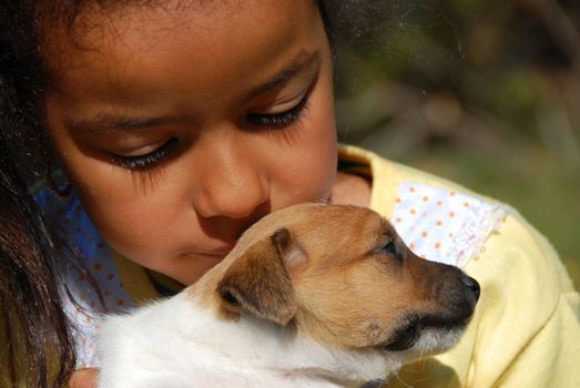little girl and her very young puppy jack russel terrier