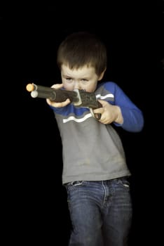Baby boy playing with a toy gun