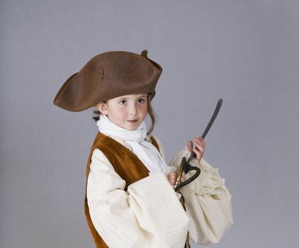 Cute little girl in a pirate costume for Halloween.