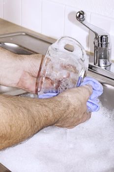 Dishwashing by hand in the kitchen sink