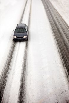 A car travelling in a snow storm