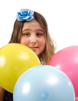 A young birthday girl surrounded by colorful balloons, isolated against a white background