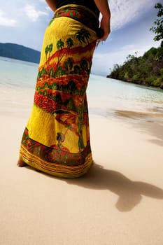 A female standing on a secluded beach
