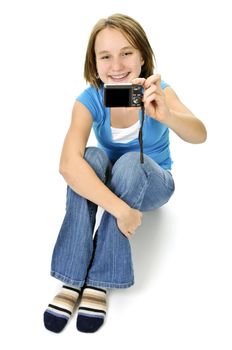 Young girl taking picture of herself in leather chair