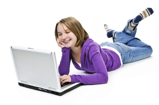 Young girl lying down with laptop computer