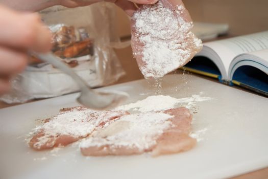 dredging meat in flour, shallow DOF, close-up