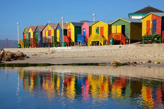 Brightly painted wooden bathing huts at St James Beach, near Cape Town, South Africa.