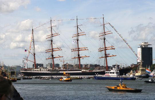AMSTERDAM, AUGUST 19, 2010: Russian tall ship Sedov being turned round by tugboats at Sail 2010 in Amsterdam, Holland on august 19, 2010