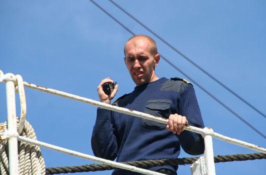 AMSTERDAM, AUGUST 19, 2010: Mate overseeing the mooring of the Russian tall ship Sedov to the quay at Sail 2010 in Amsterdam, Holland on august 19, 2010