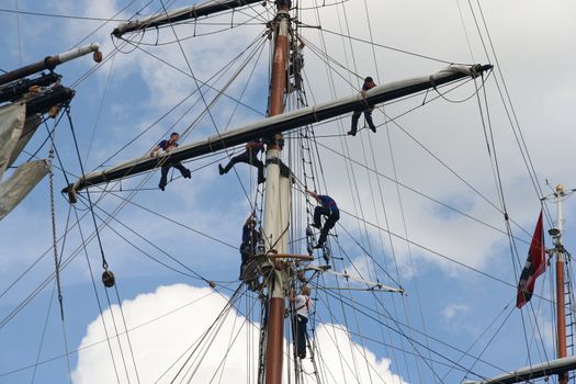 AMSTERDAM, AUGUST 19, 2010: Sailers in the mast of Dutch tall ship Stad Amsterdam at Sail 2010 in Amsterdam, Holland on august 19, 2010