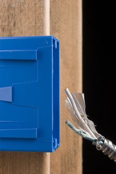 Blue switch box next to a metal cable.