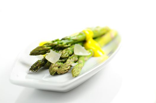 Closeup of steamed asparagus topped with parmesan cheese.