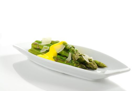 Steamed asparagus topped with hollandaise sauce and parmesan
