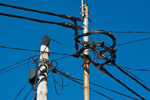 Poles with a mess of wires, taken on Madeira, Portugal.