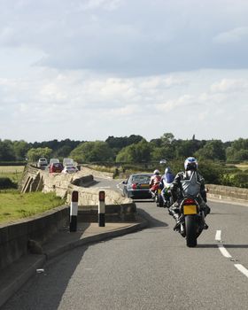 motor cyclist and cars on swarkstone bridge in Derbyshire 