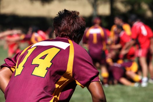 Rugby player in action on a background of players