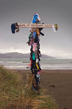 A post at the beach is covered in lost jandals. Wairarapa, New Zealand