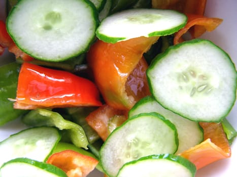 Green salad with lattuce and vegetables, peppers, cucumbers