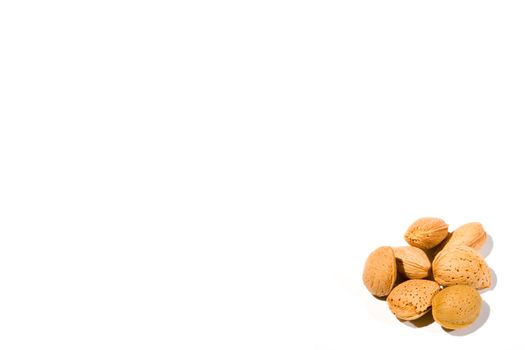 high key image of a small collection of almonds on a white background