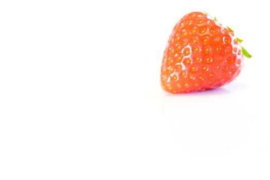 high key image of a single strawberry on a white background